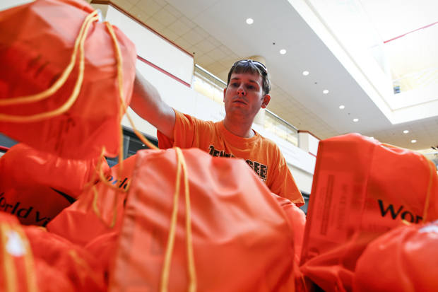 Bowling Green senior Adam Jent packs bags of supplies for aid workers in Africa and Asia as part of Veritas in Action, an event sponsored by World Vision, in Mass Media and Technology Hall on Friday. Each box contains one kit of supplies and four refill bags, which can supply one worker for one patient for one year. TANNER CURTIS/HERALD