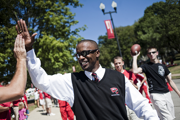 Head Coach Willie Taggart high fives fans on his walk down the hill during the Topper Walk before the opening home game on Saturday against the University of Indiana. Fans tailgated from the top to the bottom of campus in preparation for the game.