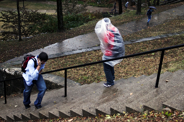 A student leaves FAC using a garbage bag as a raincoat during the sever weather on Tuesday. 