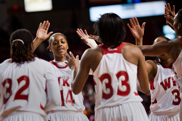 Sophomore forward Janae Howard slaps hands with her teammates at center court in Diddle Arena during WKUs Saturday afternoon game against Troy.  Howard made 7-of-11 3-point shots and scored 30 points.  WKU won 92-76. 