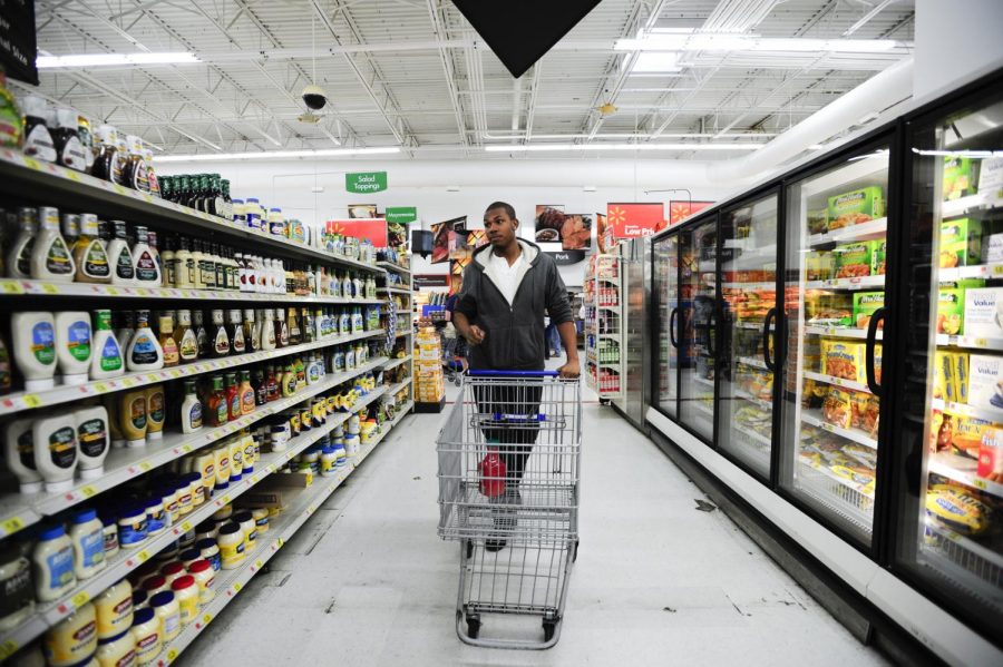 Cleveland junior Tony King shops at Walmart for juice on Friday afternoon. King, who has been participating in the Supplemental Nutrition Assistance Program (SNAP) since October, said he didn’t want to use it at first because he was embarrassed of being perceived as taking advantage of the system. Now King says he feels comfortable using SNAP to buy healthier foods and help ease the financial burden of school expenses.