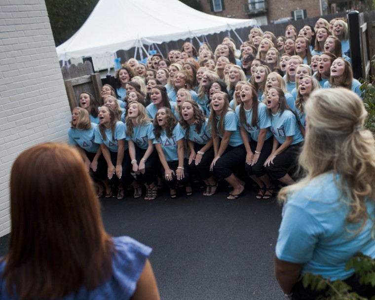 Alpha Delta Pi members sing and perform a choreographed
welcoming cheer to potential new members outside the Alpha Delta Pi
house during Rush Weeks Getting to Know You Day.
