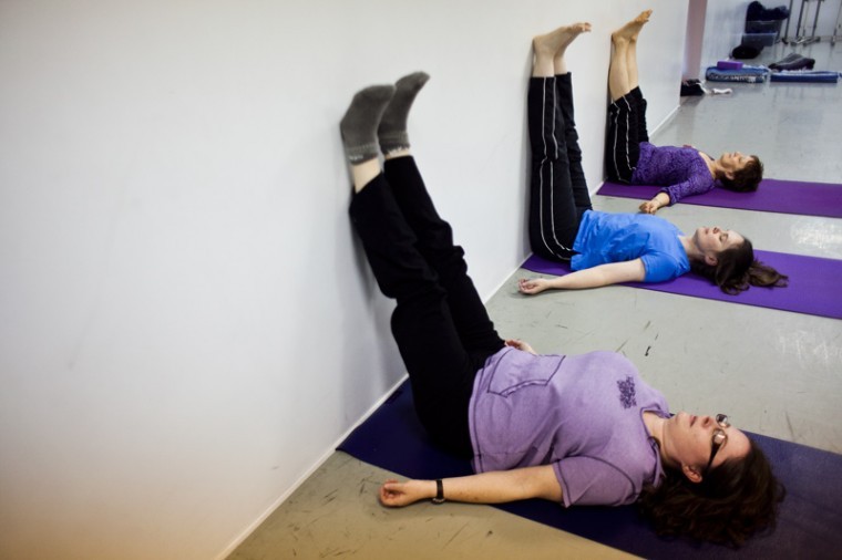 Left to right: Kelly Reames, Angela Jones and Katie Green, all
English professors at WKU, demonstrate a pose from their yoga
sessions held at Dance Images on Creason Street. Reames and Jones
offer the classes at $5 per session and said they had the budgets
of college students in mind when they set the prices.

