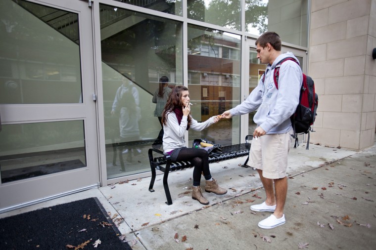 Louisville senior Zack Martin passes back the lighter
he borrows from Lewisport junior Ilea Schneider outside of the
Snell Hall. There is nothing good about it, said Martin about
social smoking. Ive only been smoking for three months. One
turned into a pack. Schneider started smoking at age 15 because
her dad smoked, but she wishes she could quit.
