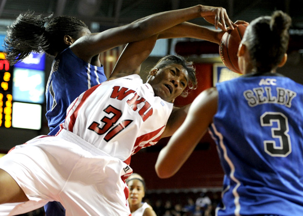 Senior forward LaTeira Owens jumps for a rebound Sunday during
WKUs 80-54 loss to Duke at Diddle Arena.
