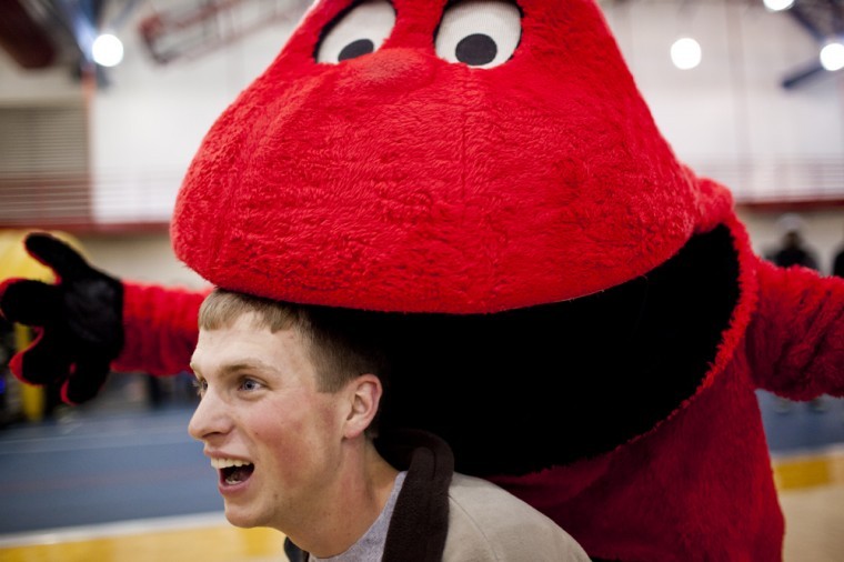 During the celebration for Big Reds birthday party at Preston
Center, La Grange freshman Matthew Lawson has his picture taken
with Big Red, who pretends to bite his head.
