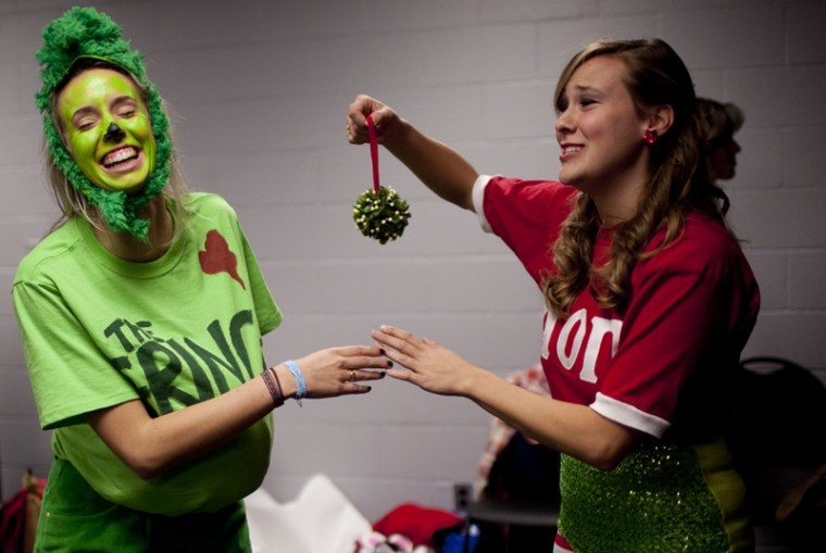 During the fifth Kappa Sigma Christmas Pageant, Louisville
senior Natalie Price and Rochester, Mich., senior Kaylee Egerer
play with a bundle of mistletoe backstage after Egerer represented
her sorority, Alpha Omicron Pi, during the letters portion of the
competition.
