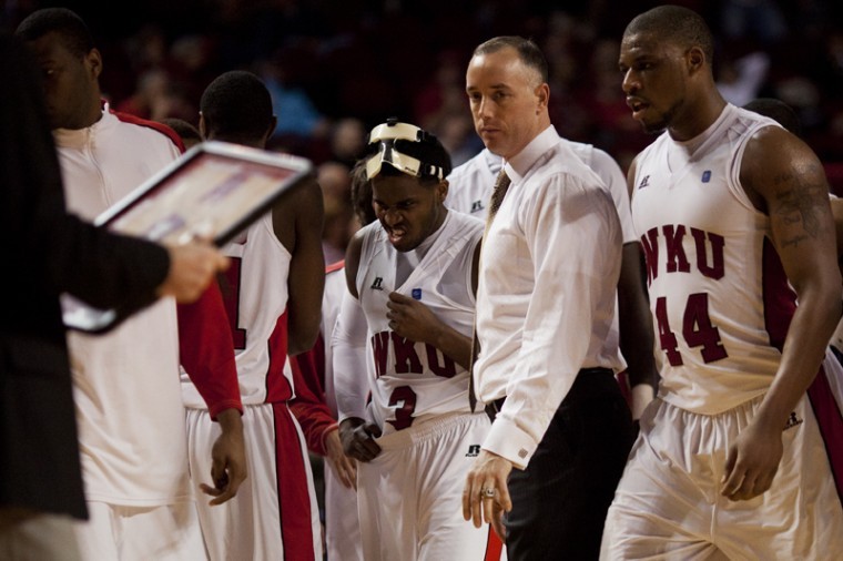 Former Head Coach Ken McDonald stands amongst his team during a
timeout of his last game, against the University of
Louisiana-Lafayette on Jan. 5, 2012. McDonald will be replaced with
Ray Harper as head coach. 
