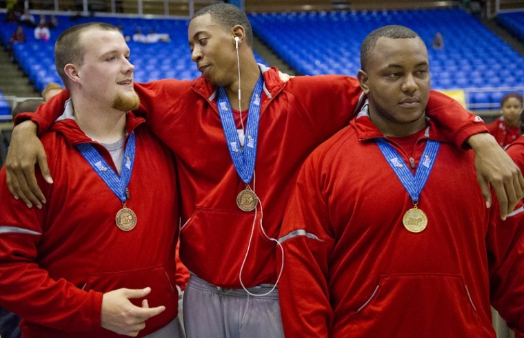 (From left) Senior thrower Brad Wright, sophomore sprinter DeMyco Winston and junior thrower Houston Croney celebrate after being awarded the championship title at the Sun Belt Indoor Championships at the Murphy Center in Murfreesboro, Tenn., Sunday.

