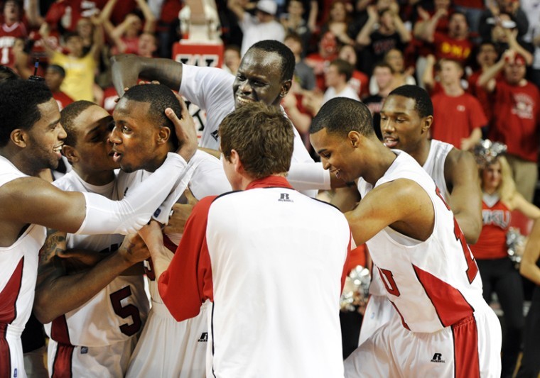 Freshman guard T.J. Price is congratulated by his teammates after making the game-winning shot Thursday night against Arkansas State in Diddle Arena. Price knocked down a 3-pointer with 2.9 seconds left to give WKU a 79-76 victory. 

