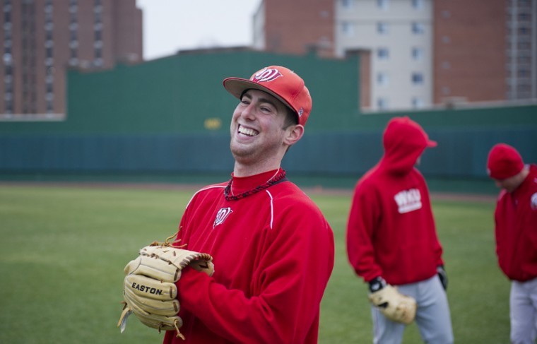 Junior left-handed starting pitcher Tim Bado, center, laughs
with teammates during practice on Feb. 8 at Nick Denis Field. Bado
has, as of now, secured a spot as the Toppers Sunday starter.
