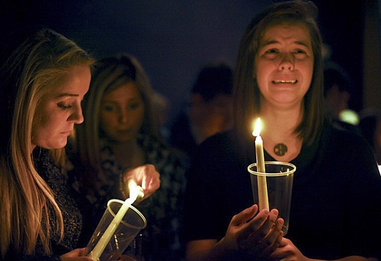 Bradley Boling’s girlfriend, Bowling Green senior Caitlin Gover
(right), and WKU alumna Katie Williams, participate in a vigil
commemorating the life of Boling Friday at the SAE house. Boling,
an SAE from Bowling Green, died Friday morning of unknown causes.
Around 100 people attended the vigil.
