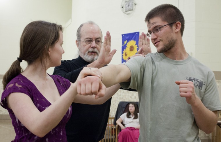 Tom Pardue, a 10th degree kung fu grand master teaches Louisville junior Amanda Reynolds and Bowling Green junior Bryant Lipp techniques for stunning an assailant during a free kung fu class at the Jones-Jaggers Hall Gym Wednesday. The class was held as a part of violence awareness month.
