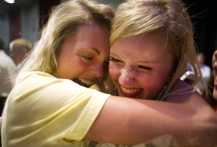 Elizabeth Mulholland receives a hug from one of her sisters in Alpha Xi Delta sorority after winning the Sigma Chi Derby Darling Pageant Wednesday night in the Downing University Center Auditorium.
