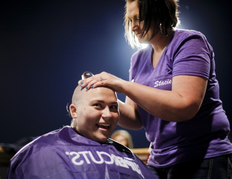 Tompkinsville sophomore Gabbi Hagan has her head shaved during St. Baldrick’s Day, an event sponsored by the Omega Phi Alpha Sorority Saturday at Nick Denes Field.
