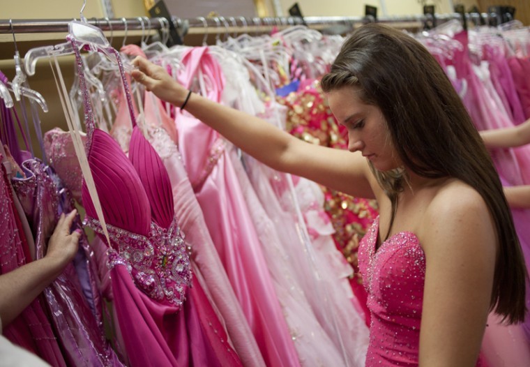 Sheridan Strickland, a high school junior from Newburgh, Ind., looks at prom dresses at Michelle’s Consignment Boutique while in Bowling Green for a college visit at WKU. Michelle Odle has owned the shop for six years.
