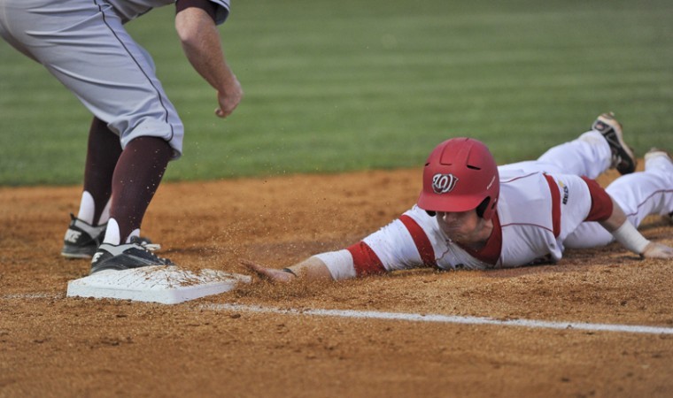 Senior infielder Ivan Hartle slides back to first after attempting to steal second Friday at Nick Denes Field against Arkansas-Little Rock. Hartle is one of five seniors on the roster for the Toppers.
