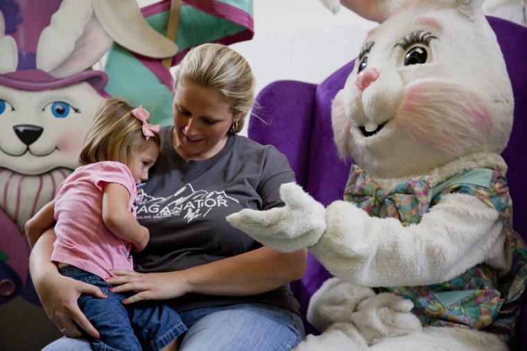 The Easter Bunny, played by WKU freshman Kristina Johnson, Bowling Green, tries to get a high five from four-year-old Emma Carpenter Thursday afternoon in Greenwood Mall.
