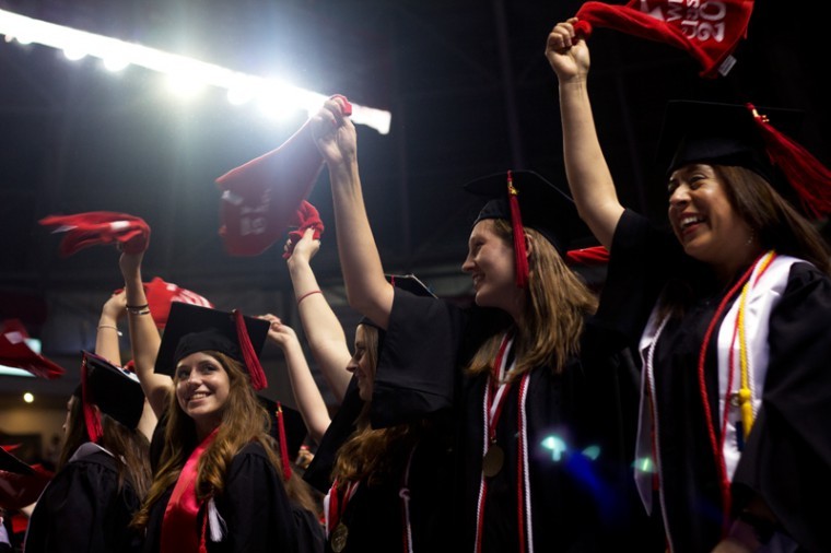 New+graduates+wave+their+red+towels+during+one+of+the+171st+Undergraduate+Commencement+ceremonies.+The+ceremonies+took+place+at+Diddle+Arena+on+Saturday%2C+May+12.%0A