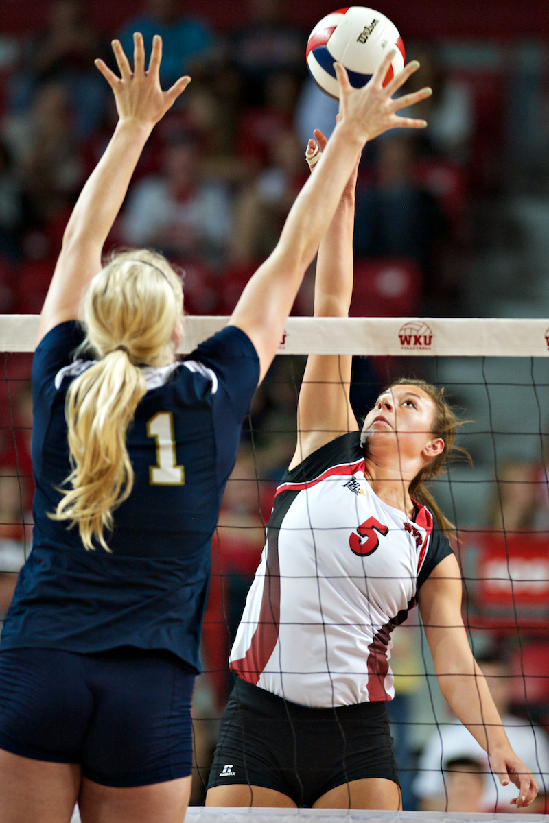Western Kentucky's Lindsay Spears (right) spikes the ball past Florida International's Kimberly Smith during the game Friday, Oct. 12, 2012 at Diddle Arena. Nationally ranked No. 20 Western Kentucky defeated Florida International 3-0. The Lady Toppers have now won 13 games in a row.

