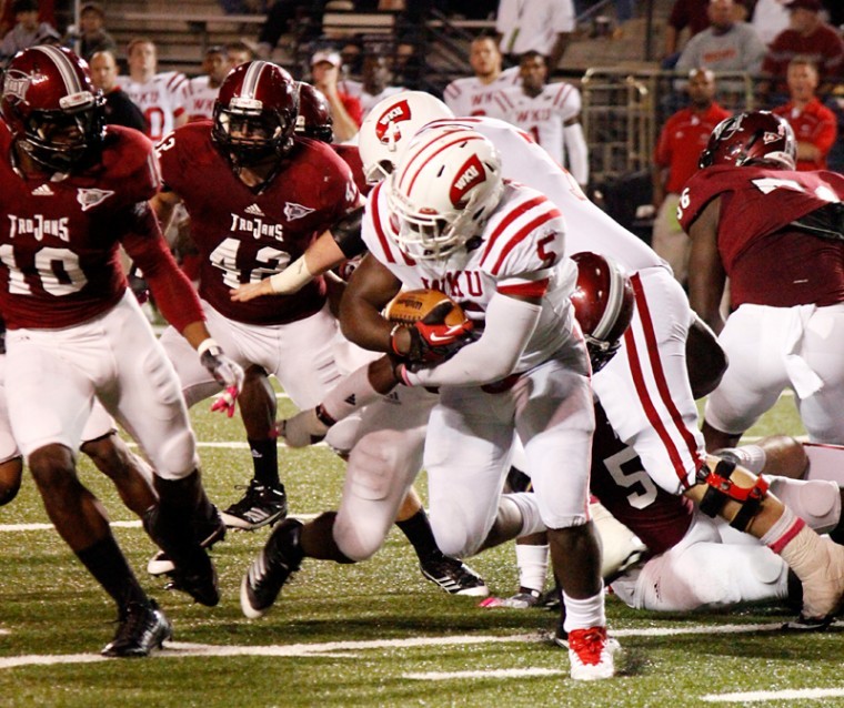 WKU running back Antonio Andrews (5) runs the ball against the Troy Trojans defense during a play at Troy University on Thursday, Oct. 11.
