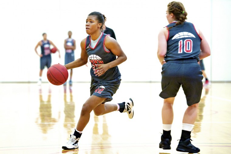 Junior guard Bianca McGee, left, runs past sophomore guard Danay Fothergill to shoot the ball during the first practice of the season Monday, Oct. 1, 2012 at the practice gymnasium inside E.A. Diddle Arena.
