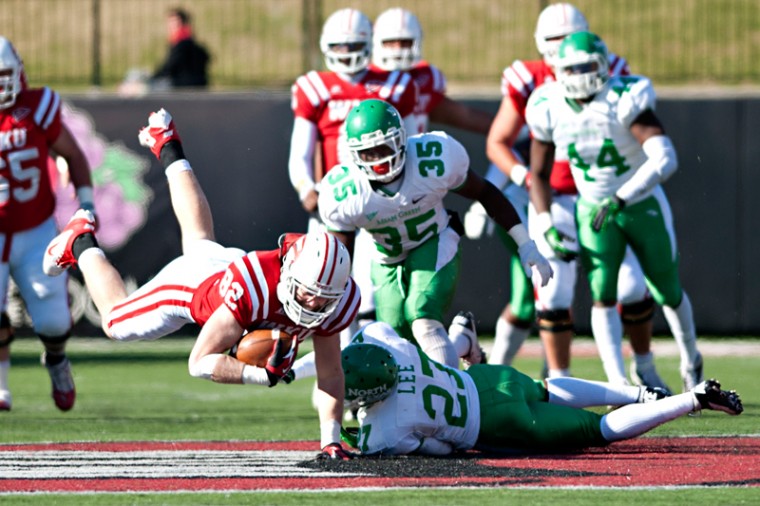 Senior tight end Jack Doyle (from left) is brought down by North Texas junior linebacker Zach Orr and sophomore strong safety Lairamie Lee during the game Saturday, Nov. 24, 2012 at Houchens-Smith Stadium.
