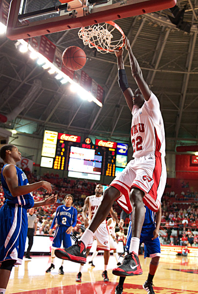 Senior center Teeng Akol dunks the ball against Brescia. Akol had 11 points in the game. WKU won 74-46 against Brescia on Saturday Nov. 24, 2012 at Diddle Arena.
