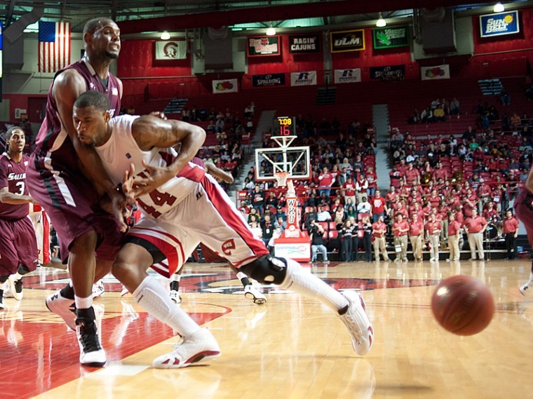 Sophomore forward George Fant loses the ball after running into Southern Illinois forward Dantiel Daniels during their game Wednesday night at Diddle Arena. The Tops won the game 58-57.
