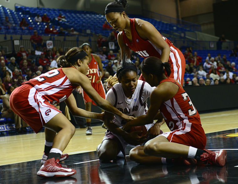 WKU players attempt to steal the ball University of Arkansas Little Rock freshman forward Shanity James in the second half of their semi-final Sun Belt Conference Game.
