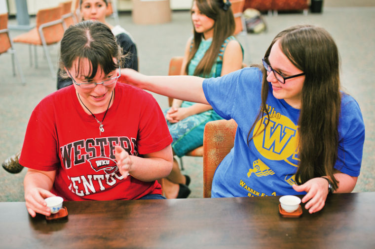 Hendersonville, Tenn., freshman Claire Parsons and Bowling Green freshman Leslie Johnson partake in a tea ceremony held by the Chinese club on Wednesday. Served along with the tea were Chinese snack foods, such as red bean mochi. Im addicted to those now, Johnson said.
