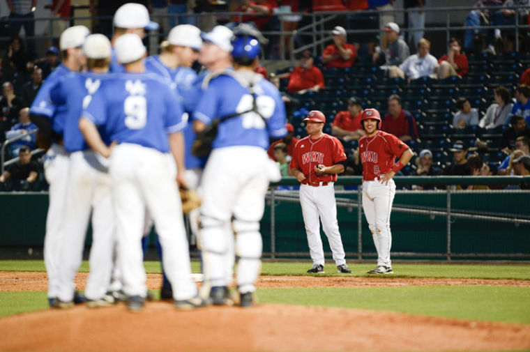 WKU Assistant Coach Blake Allen and senior infielder Steve Hodgins watch Kentuckys meeting at the mound during WKUs game against UK Tuesday. The Hilltoppers defeated the 24th-ranked Wildcats 3-2 in 18 innings
