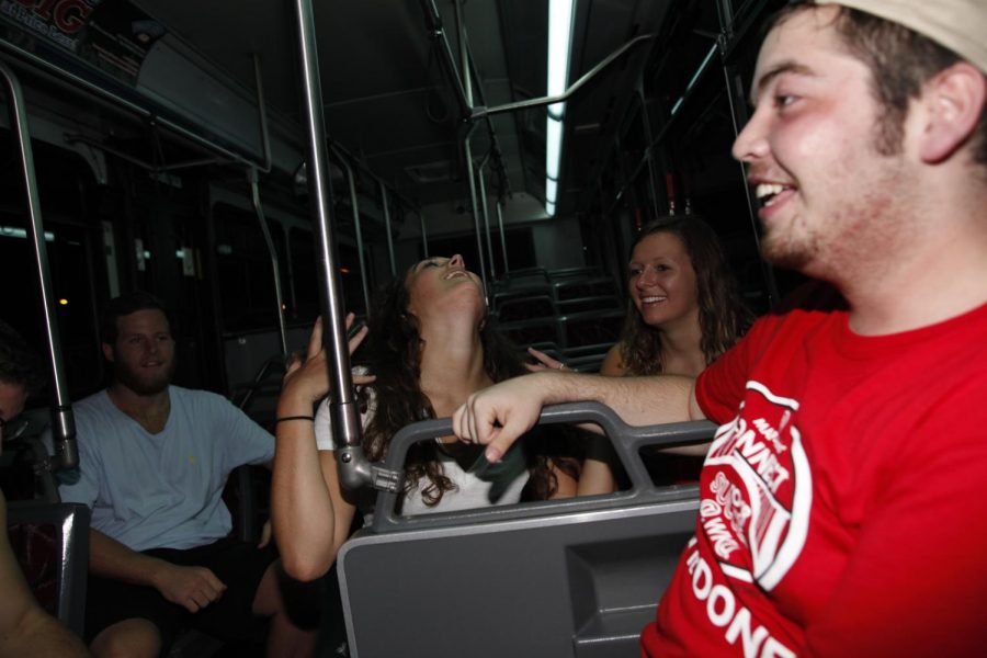 Lexington freshmen Alex Buckles (Left), Lexington freshman Ellen Stone, and Lexington freshman Miranda Jenkins, and Glasgow freshman Marcus Piper sing along to music playing on the Purple Line bus on Friday night. I am known for good music, said Quinten Haynie, the Purple Line bus driver. Haynie creates his own mixed CDs for his weekend routes. 