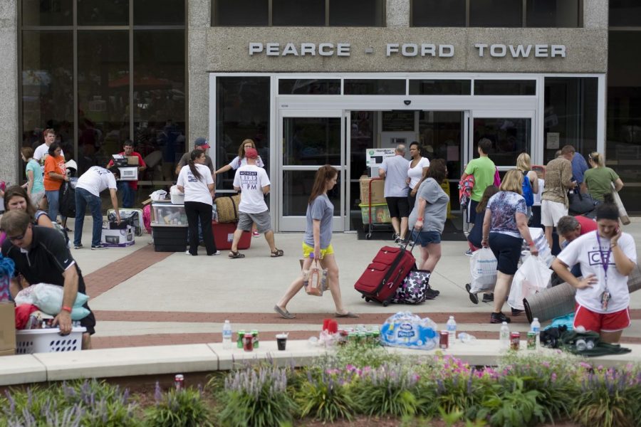 Girls with their families move into Pearce Ford Tower during MASTER Plan move in day on Sunday. This is the first semester the building will house only females.