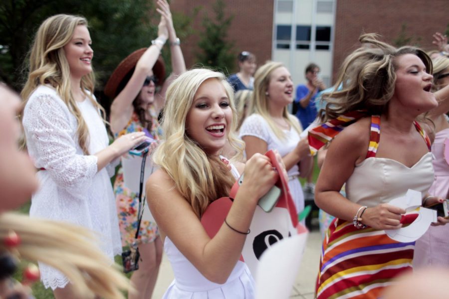 Nashville freshman Holly Reynolds (center), a new member of Alpha Omicron Pi, shouts her first chant with her new sorority in front of MMTH during Bid Day on Sunday, Aug. 25.
