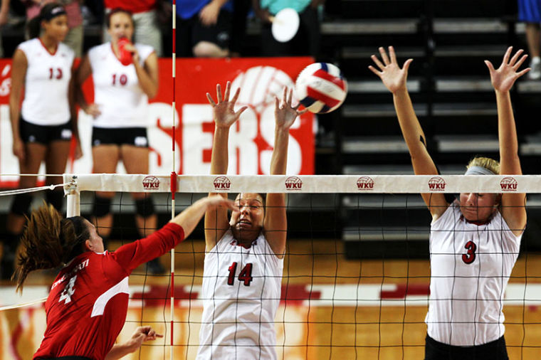  Lady Topper junior middle hitter, Heather Boyan, right, and senior setter, Melanie Stutsman, left, miss a spike against University of Cincinatti sophomore defensive setter, Morgan Allred. WKU defeated the Bearcats in a three-set sweep. (25-15, 25-10, 25-14) 
