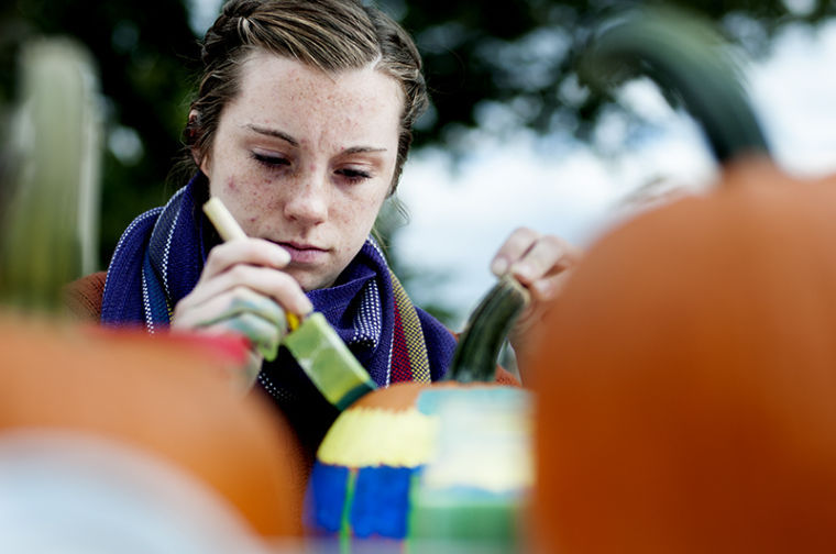 Lexington freshman Lauren English paints a pumpkin at the B.O.O. event put on by the Horticulture Club and Green Toppers. The pumpkin sale featured painting supplies to decorate pumpkins with free hot chocolate and free apple cider from Jacksons Orchard.