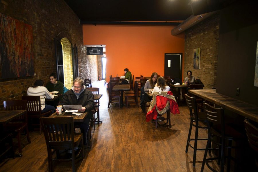 Customers relax in the new remodeled interior of Spencers Coffee on Monday, Jan. 27. The coffee shop recently reopened in this location after a brief period of operating in the lobby of the building next door during renovations. (Demetrius Freeman/ HERALD)