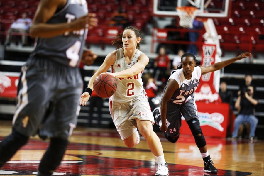 WKU+senior+guard+Chaney+Means+dribbles+the+ball+up+court+past+Troy+freshman+guard+Chant+Lewis+during+the+second+half+of+their+at+Diddle+Arena%2C+Wednesday%2C+February+12th%2C+2014.+The+Lady+Toppers+won+the+game+93-66.+%28Ian+Maule%2FHERALD%29