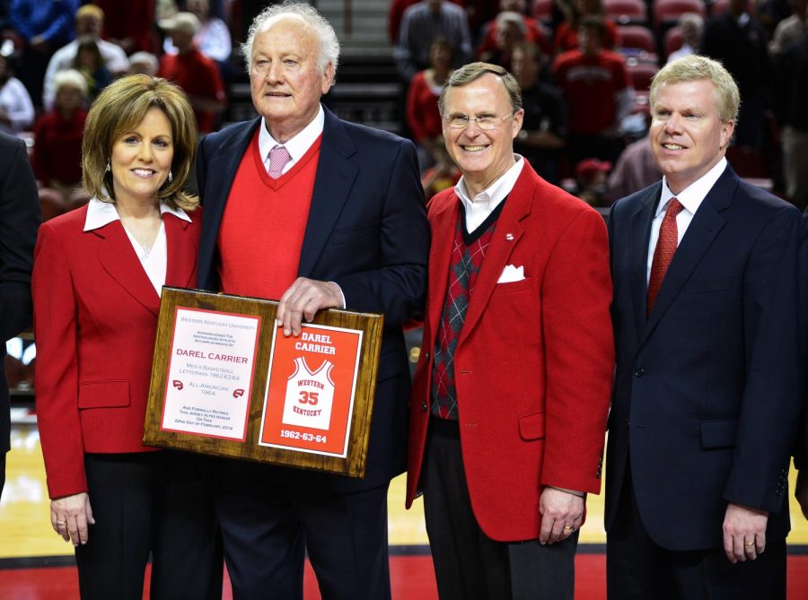 Former+WKU+basketball+player+Darel+Carrier+poses+for+a+photo+with+his+wife%2C+Donna%2C+President+Gary+Ransdell+and+Athletic+Director+Todd+Stewart+as+his+jersey+number+is+retired+during+a+special+halftime+ceremony+on+Feb.+22.+Carrier+played+for+WKU+from+1962-64%2C+and+became+the+eighth+Hilltopper+to+have+his+jersey+retired.+%28Ian+Maule%2FHERALD%29