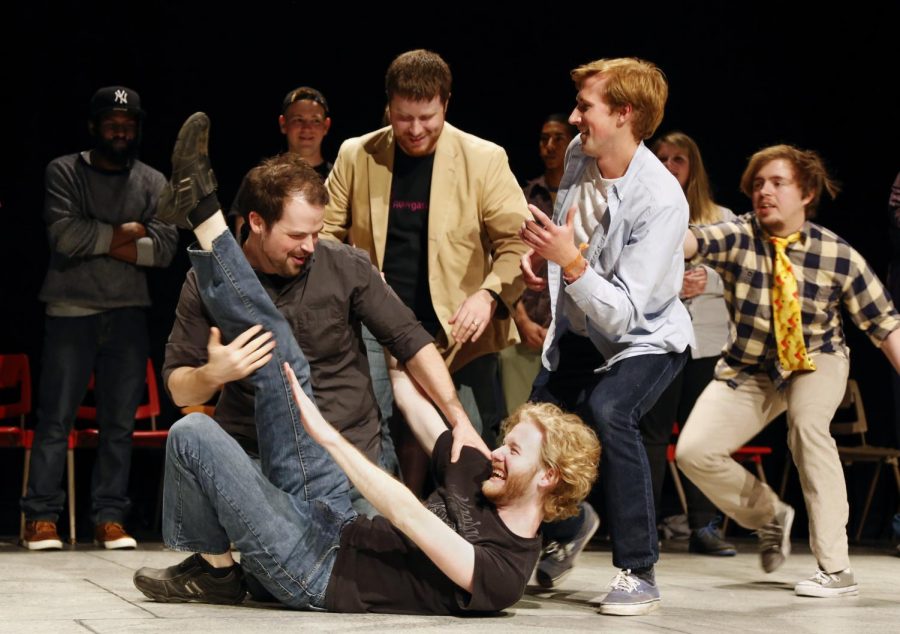 Happy Gas founder WKU alumnus Josh Chapman (far left) performs an improv skit called ÒFreeze FrameÓ with WKU alumnus Sebastian Kearney (center), Franklin, Tenn., senior Nick Benson and approximately 25 other members of the comedy troupe during the 15th Anniversary Show at the Russell Miller Theatre in the Fine Arts Center on Saturday. (Tyler Essary/HERALD)
