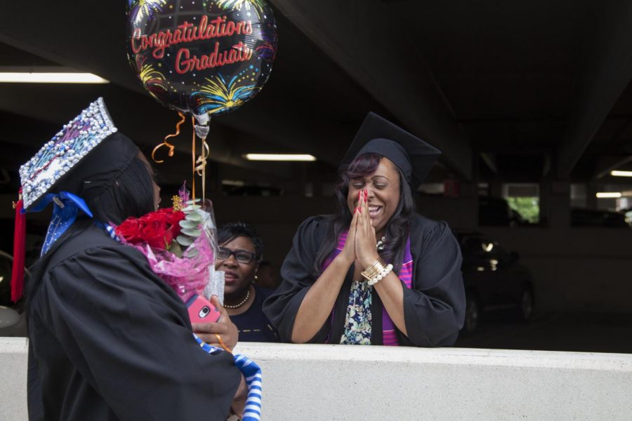 Keira Martin of Louisville (left) laughs with Brandi Beckham of Lexington (right) after WKU's commencement ceremony for the Potter College of Arts and Letters and the University College Saturday, May 17, 2014, outside E.A. Diddle Arena. (Mike Clark/HERALD)