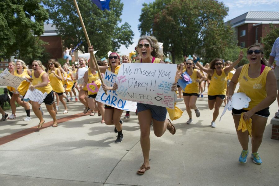 Taylor Bradley, right, of Henderson, and Taylor Reid of Hopkinsville, run to greet their new Alpha Delta Pi sisters outside of Downing Student Union on Sunday, Aug. 24. Nick Wagner/HERALD