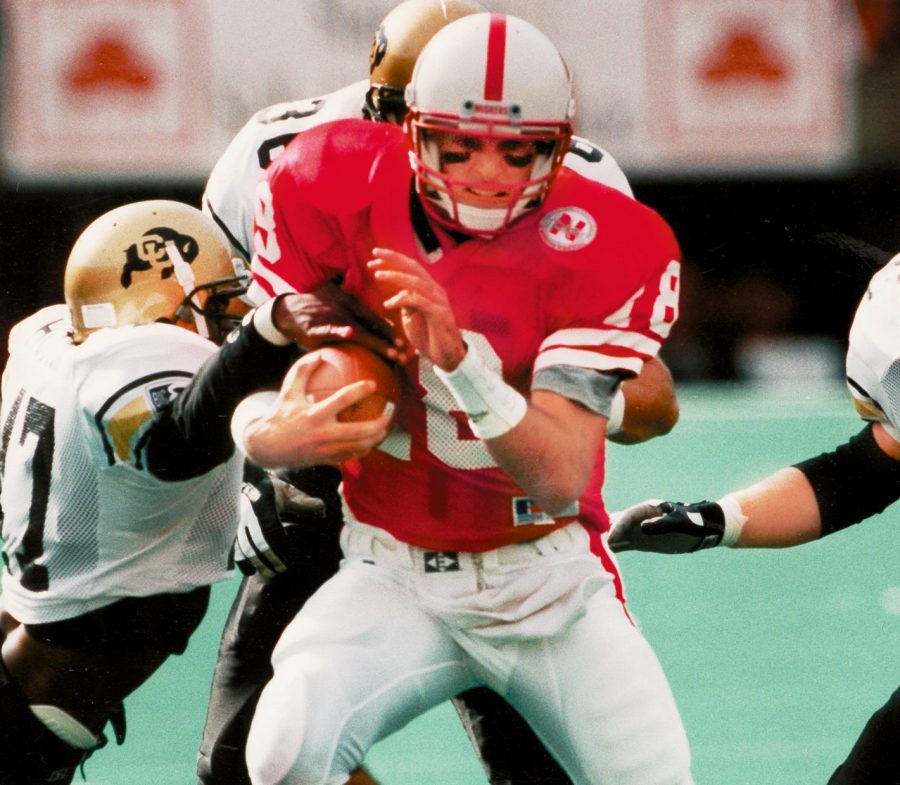 Nebraska Quarterback Brook Berringer (center) is brought down by Colorado defenders Chris Hudson (left), Jon Knutson (back), Matt Russell (16) and Ted johnson (right) on an 11 yard run in the first quarter. October 1994 UNL/COlorado Ted Kirk Photo