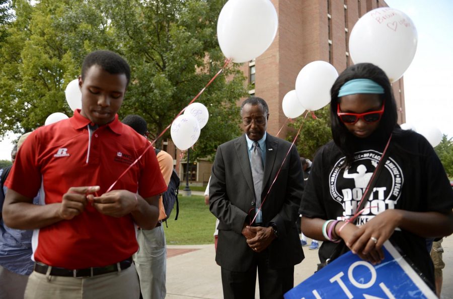 Western Kentucky University Vice Provost and Chief Diversity Officer Richard Miller prays before the Call to Action march and vigil on Sept. 16, 2014. Activists marched with balloons that commemorate African-Americans that have died in altercations with police. Harrison Hill/HERALD