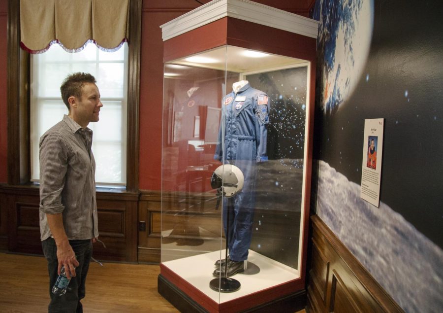 Michael Rosenbaum, class of 1995, reads information about Lt. Col. Terry Wilcutt, 1974, during his visit to the Kentucky Museum on Tuesday. Rosenbaum viewed the Instruments of American Excellence exhibit, which is where the suit he wore portraying Lex Luthor in the television series Smallville will appear on display. Nick Wagner/HERALD