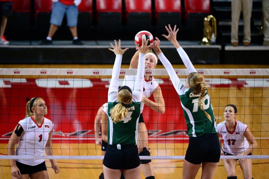WKU+senior+middle+hitter+Heather+Boyan+%283%29+spikes+the+ball+as+two+Charlotte+players+block+on+Oct.+7.+Harrison+Hill%2FHERALD