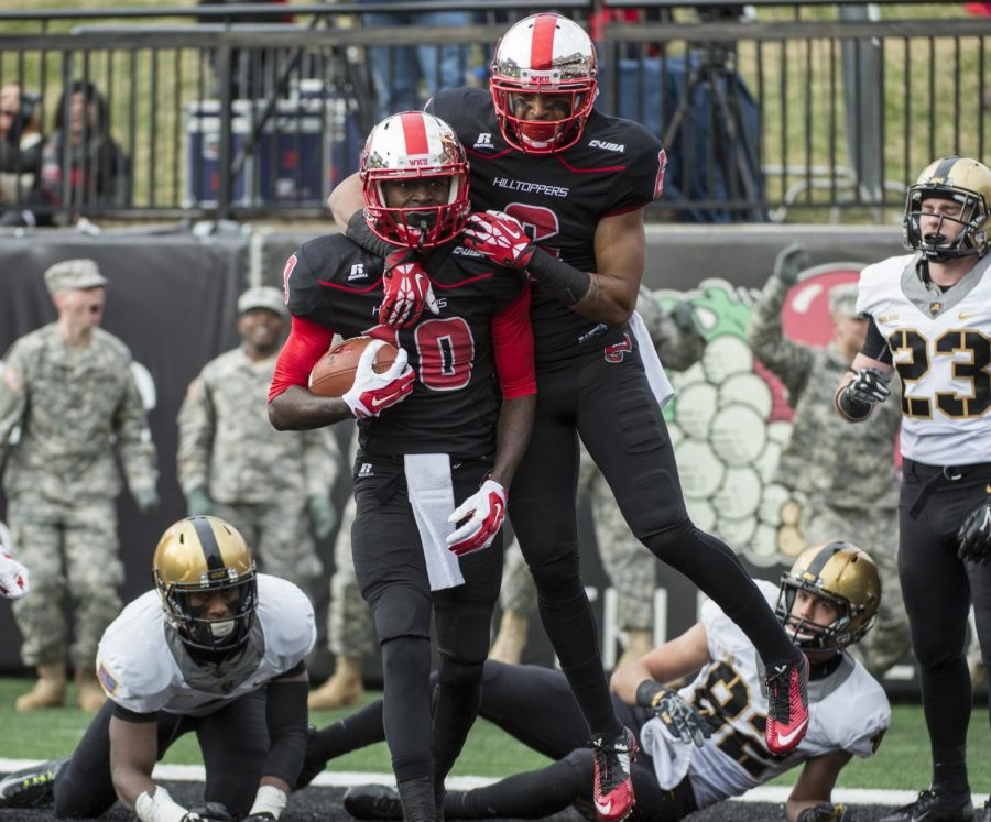 Joel German hops on the back of Willie McNeal after a hail mary touchdown reception at the end of the first half of Saturdays game against Army at Houchens-Smith Stadium in Bowling Green, Ky. Nick Wagner/HERALD