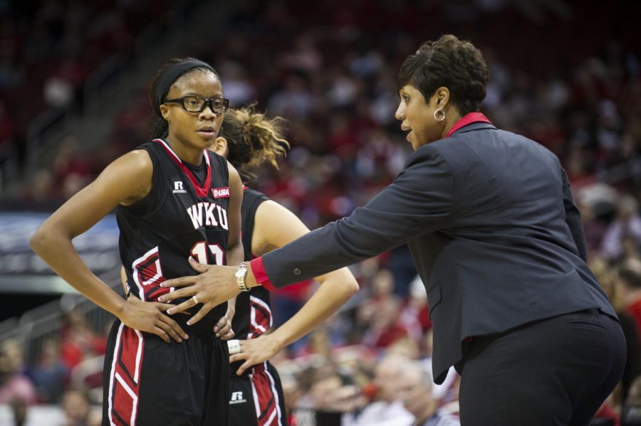 Head Coach Michelle Clark-Heard converses with Tashia Brown during a timeout in the Lady Toppers game against the University of Louisville at the Yum! Center, November 25, 2014. Justin Gilliland/HERALD