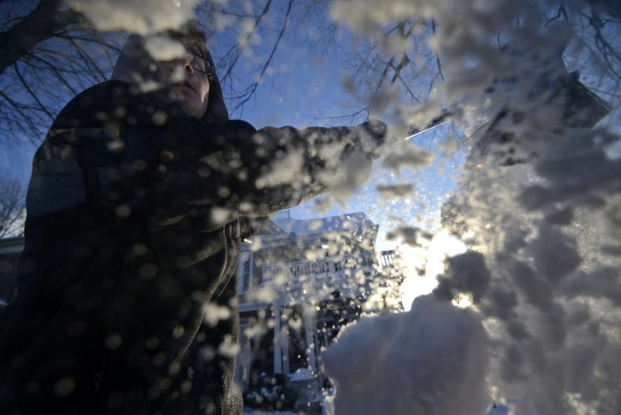 WKU sophomore Isaac Stevens of Morganfield brushes snow off of his car on East Main Ave. on Wednesday, Feb. 18.